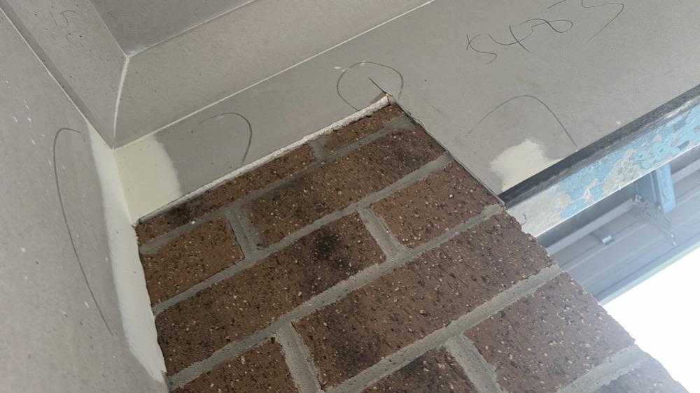 Plaster not brought flush at the garage wall, noted during a fixing inspection in Melton South